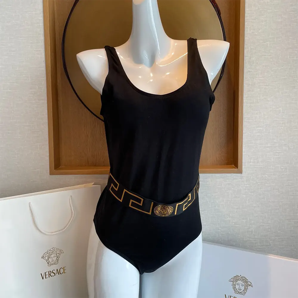 Close-up of Greca border and gold hardware on black swimsuit