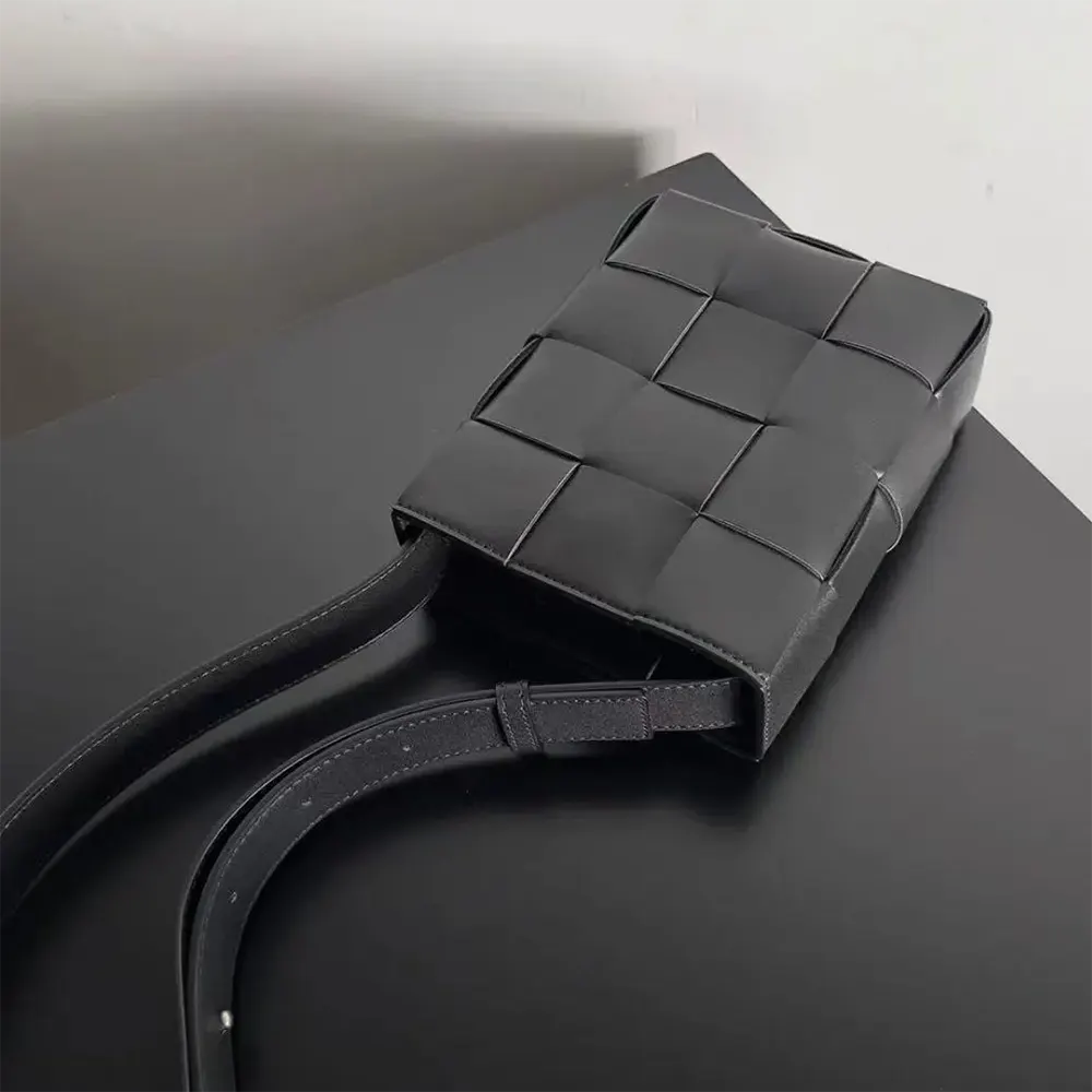 Side angle showing matte black hardware on Bottega Veneta Mini Cassette bag