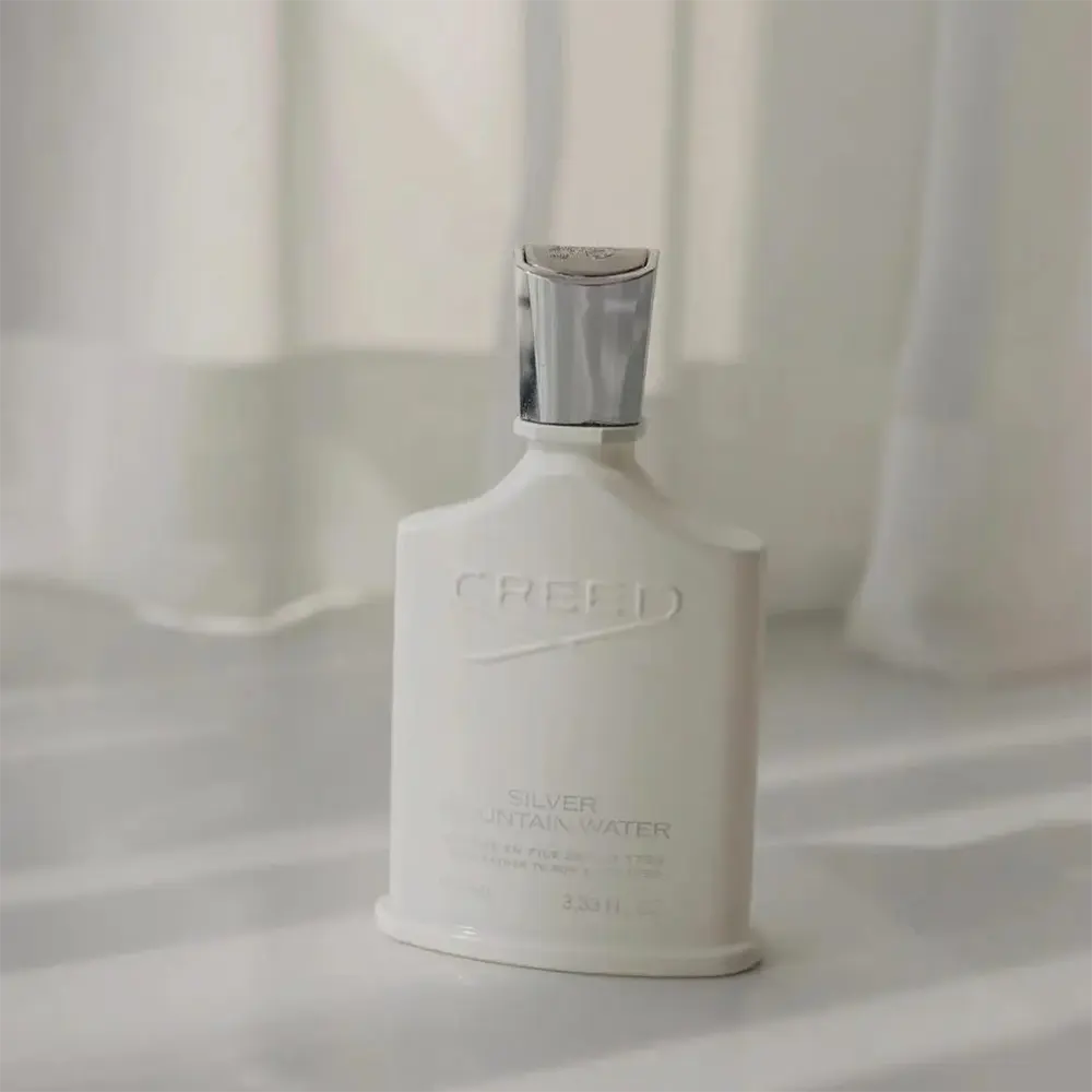 Side angle showing the signature white bottle of Creed Fragrance Men Silver Mountain Water