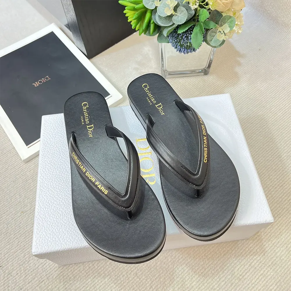 Close-up on embossed Dior logo on thong sandal strap