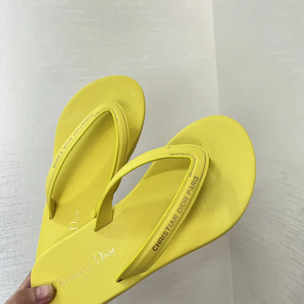 Close-up of yellow leather-effect fabric on Diorsea thong sandal