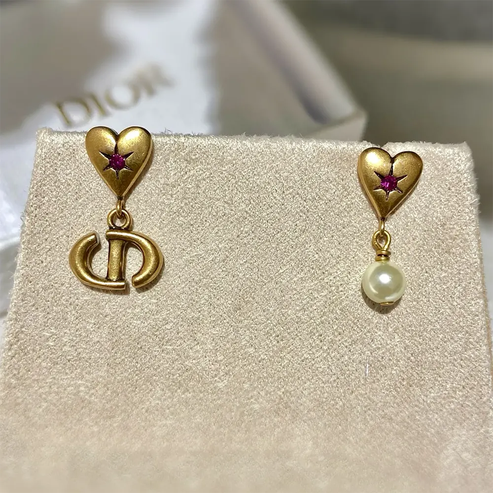 Close-up detail of antique gold finish on Dior Women Lucky Charms Earrings