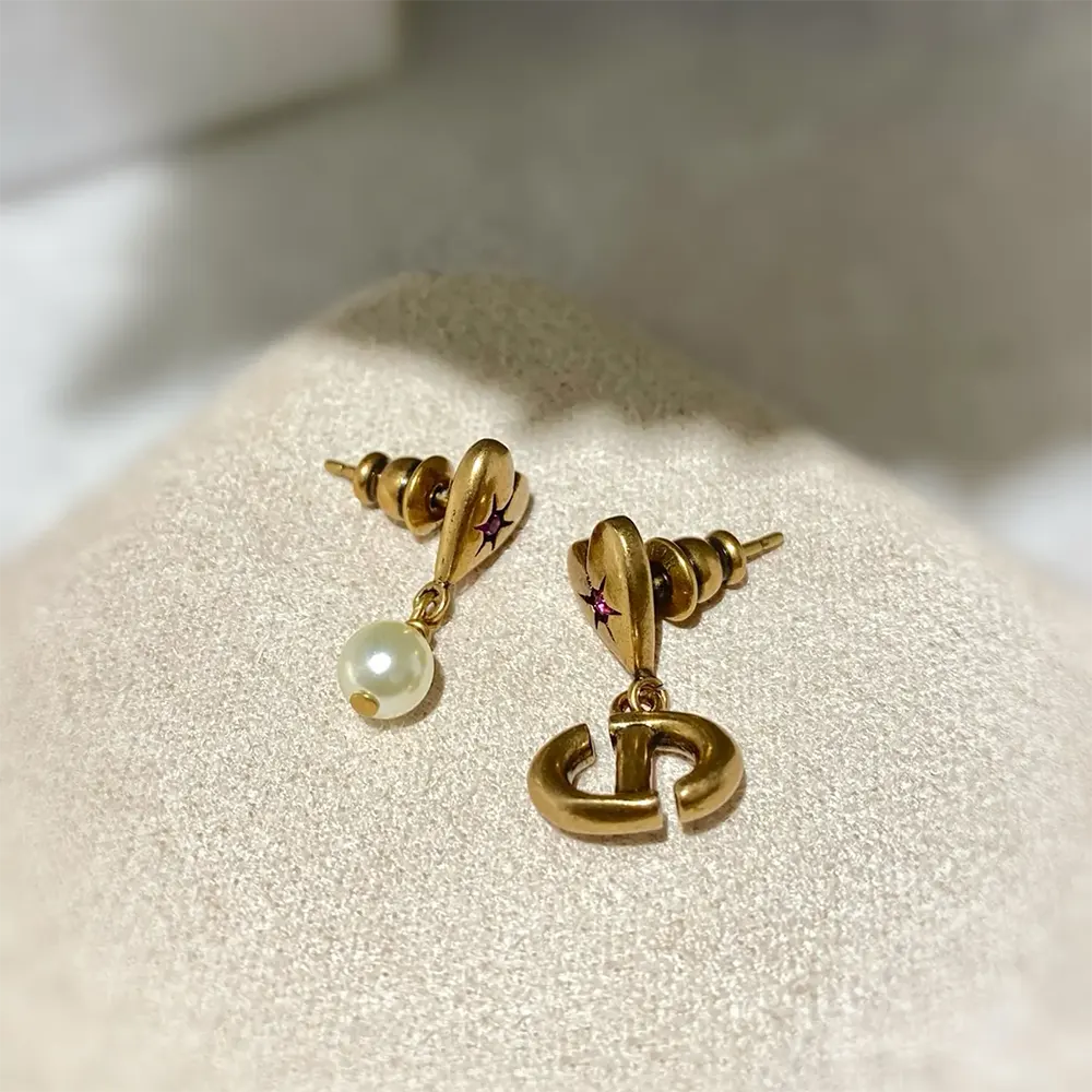 Side angle showing clasp and charm details of Dior Women Lucky Charms Earrings