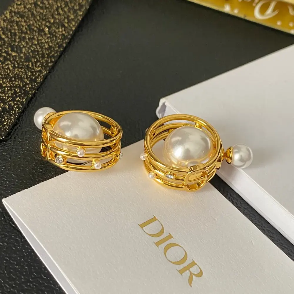 Side angle showing double-sided design of Dior Women Tribales Earrings