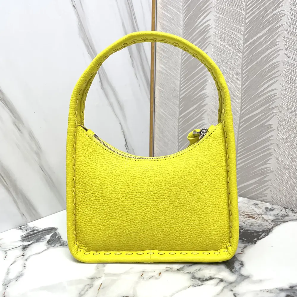 Side profile showing gold hardware and flap closure on Fendi yellow bag