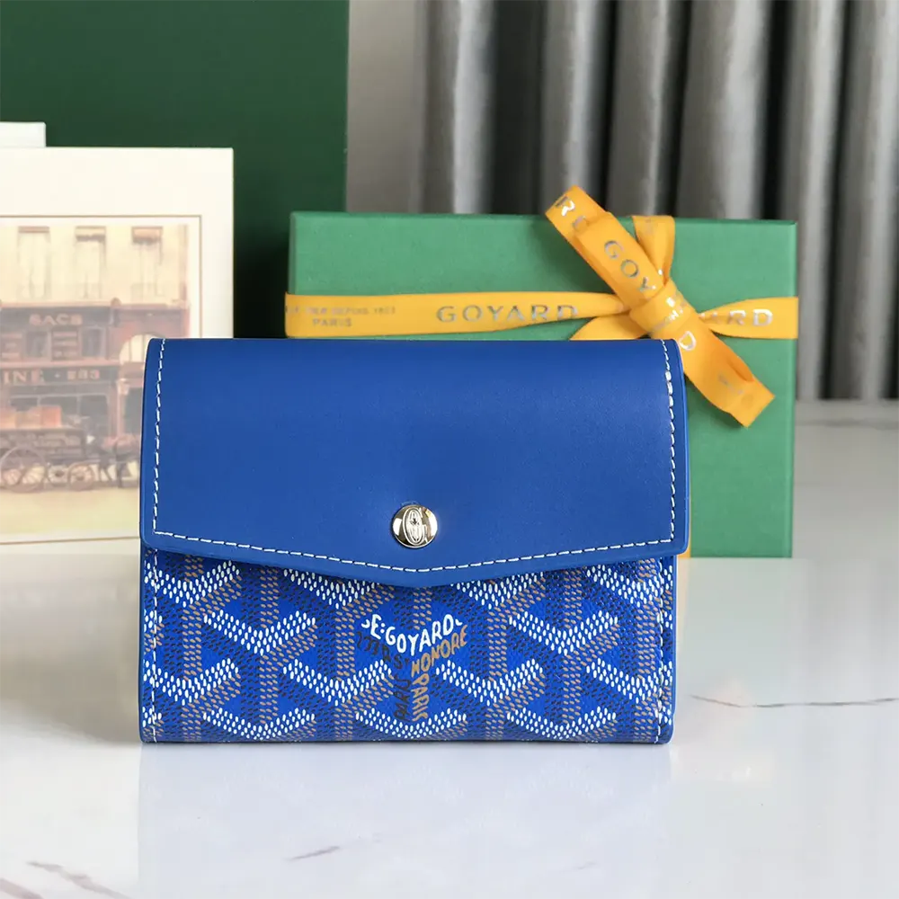 Close-up detail of blue Goyardine canvas and gold hardware on wallet
