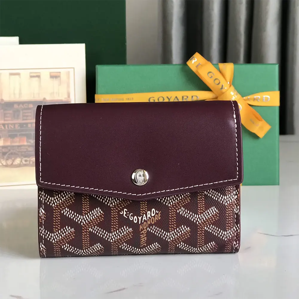 Close-up of maroon Goyardine canvas and hand-painted chevron motif wallet