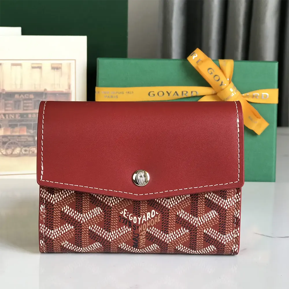 Close-up of red leather trim and brass hardware on Goyard Unisex Saint Gabrie Wallet-Red