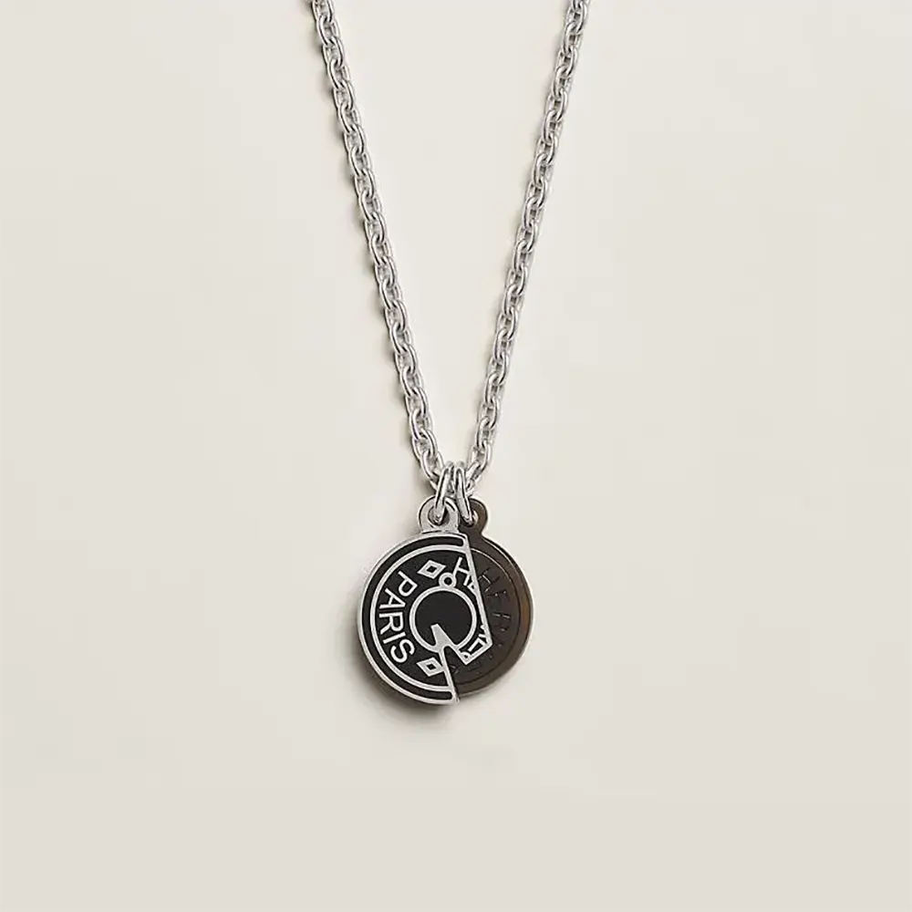 Close-up of Hermes Unisex Carrousel Necklace silver charm detail
