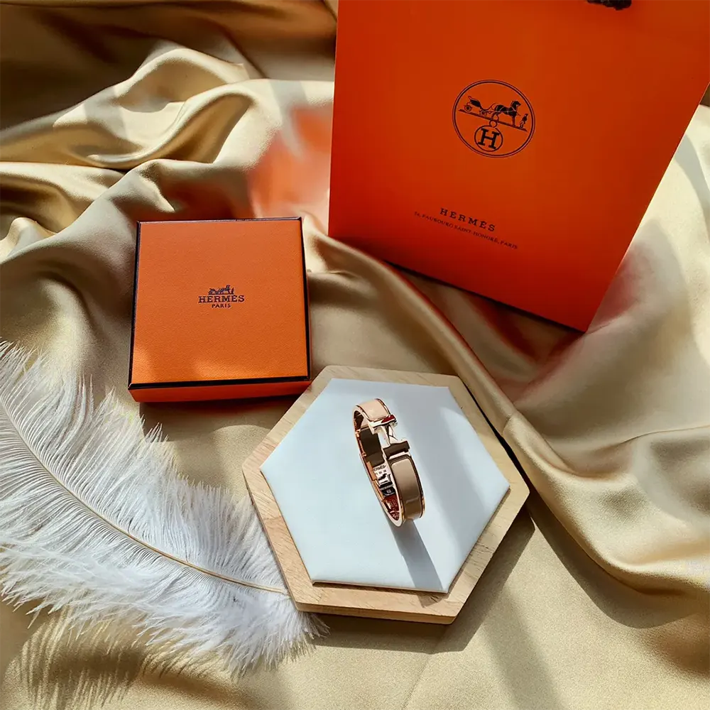Side angle of Hermes Unisex Clic H Bracelet-Brown on wrist