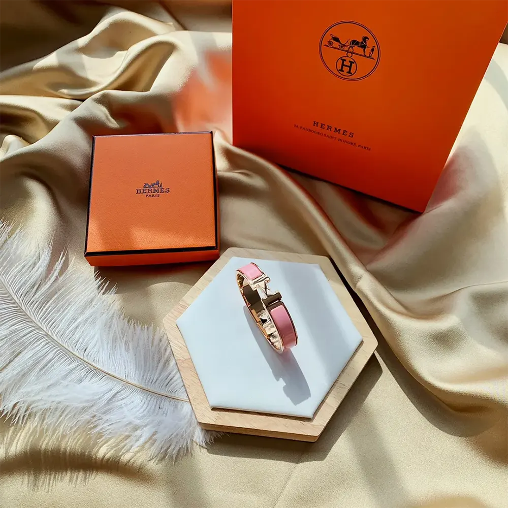 Side view of Hermes Unisex Clic H Bracelet-Pink showing enamel finish