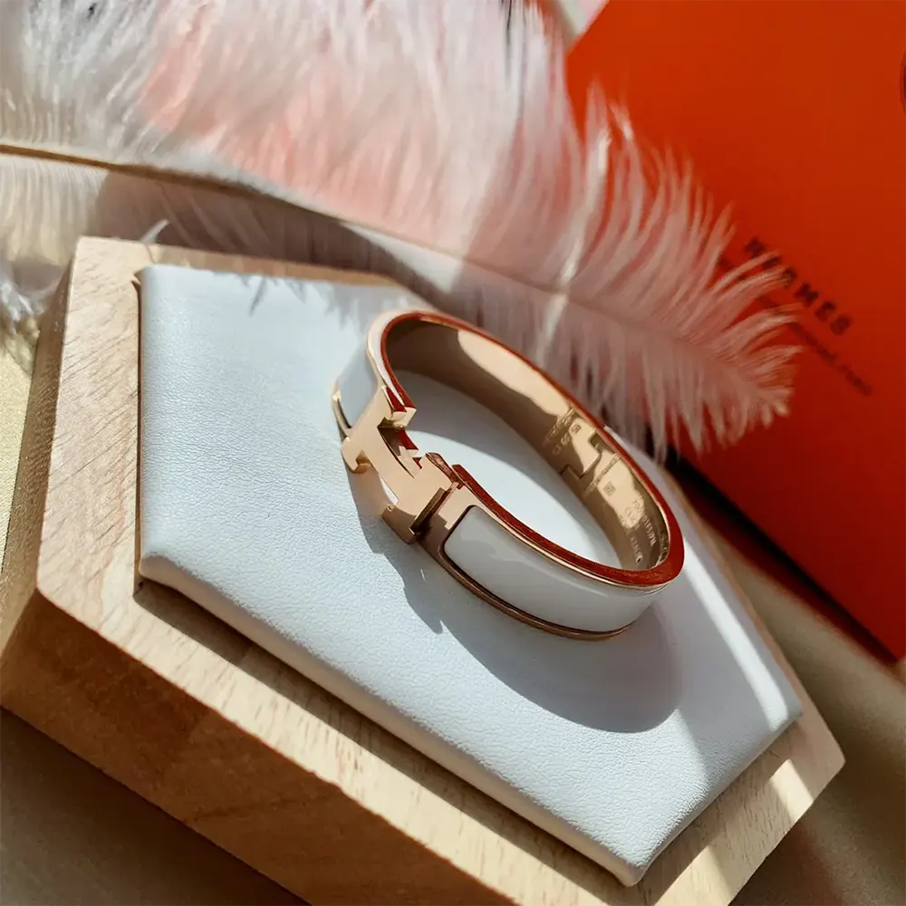 Side view of Hermes Unisex Clic H Bracelet-White showing slim profile