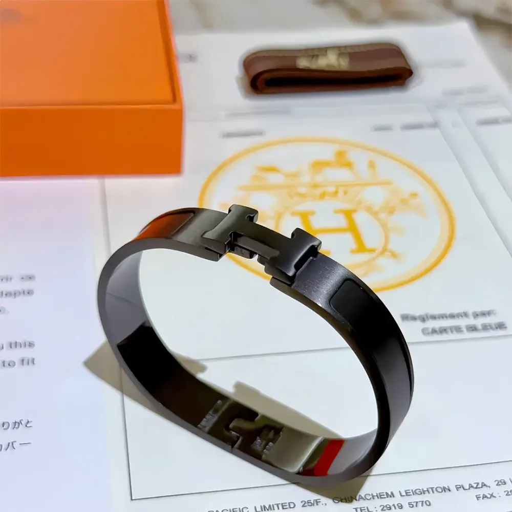 Side view showing slim profile of Hermes Unisex Clic HH So Black Bracelet