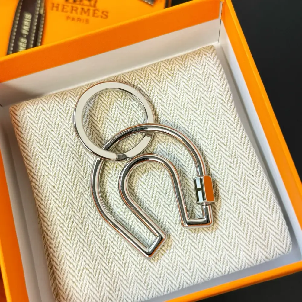 Side angle showing sleek silhouette of Hermes Unisex Fer A Cheval Key Ring
