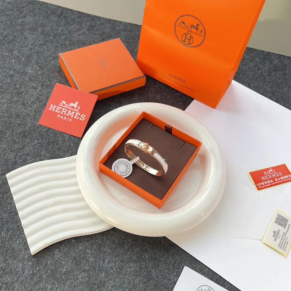 Side view of Hermes Unisex Mini Clic Kelly Bracelet-White on wrist