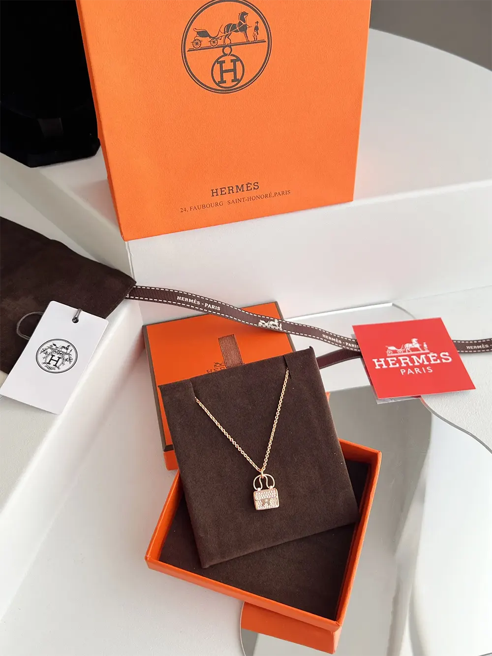 Side angle of Hermes Women Amulettes Constance Pendant highlighting pendant shape