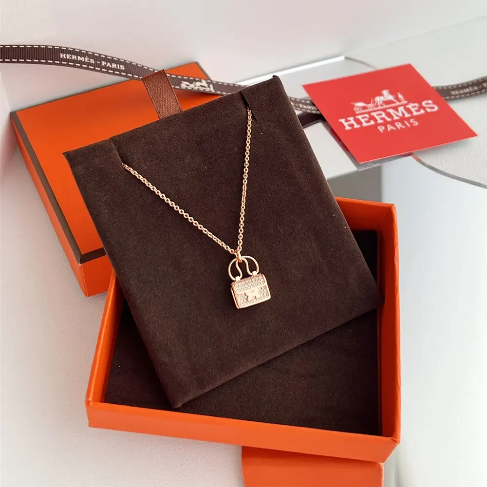 Hermes Women Amulettes Constance Pendant displayed on model's neckline