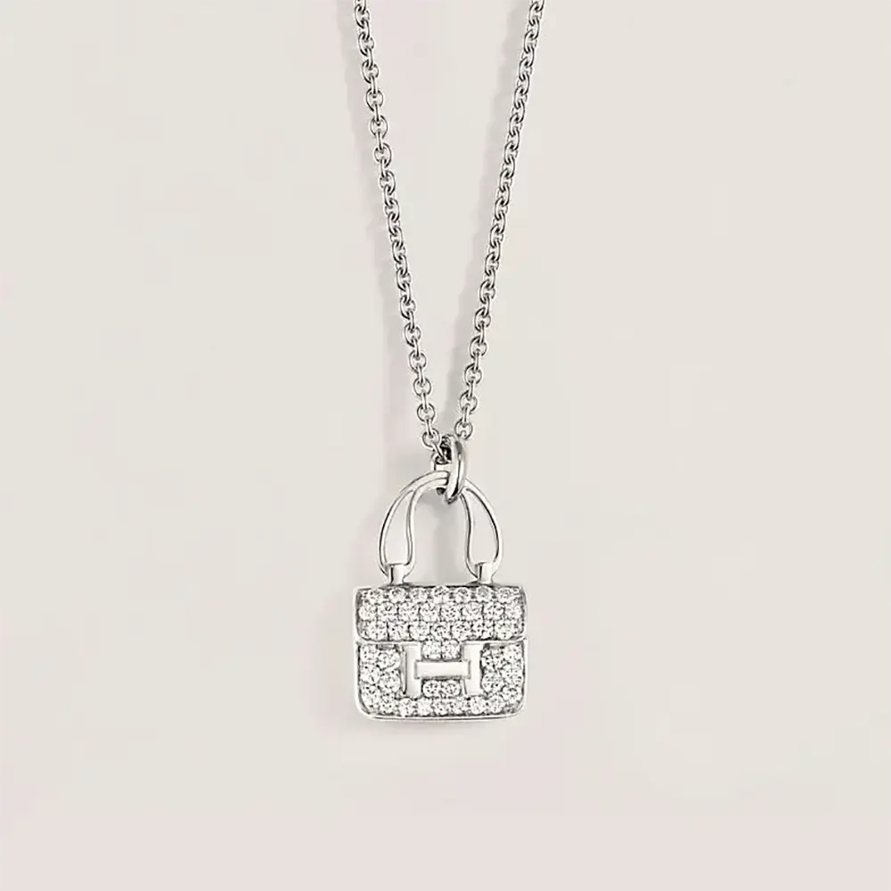 Close-up of Hermes Women Amulettes Constance Pendant silver detail