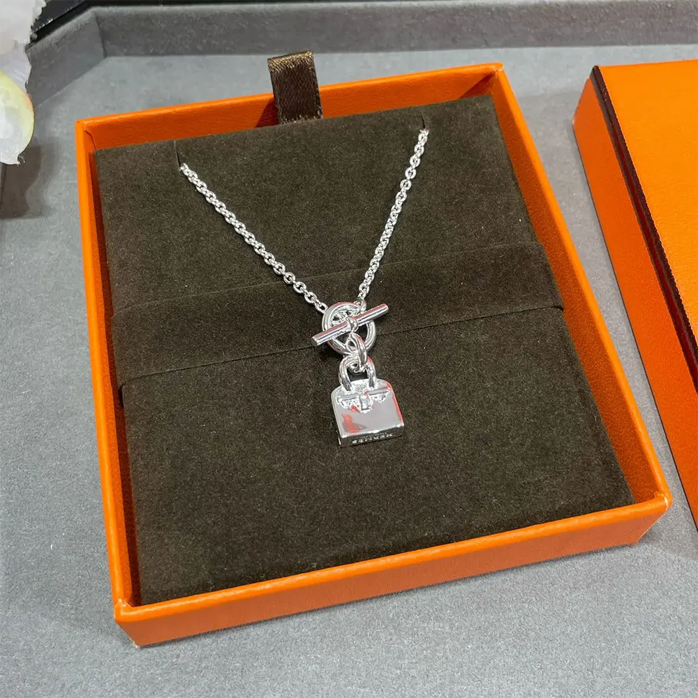 Side angle showing clasp and shine on Hermes Women Amulettes Kelly Pendant