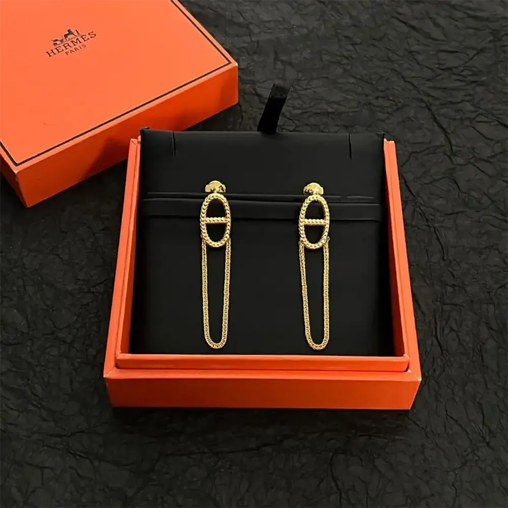 Side profile of Hermes Women Chaine D Ancre Danae Earrings on model