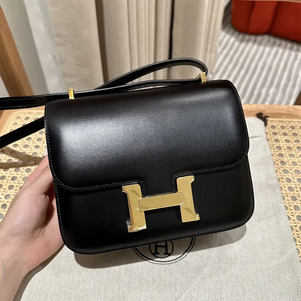 Close-up of gold 'H' closure on Hermes Women Constance 18 Bag