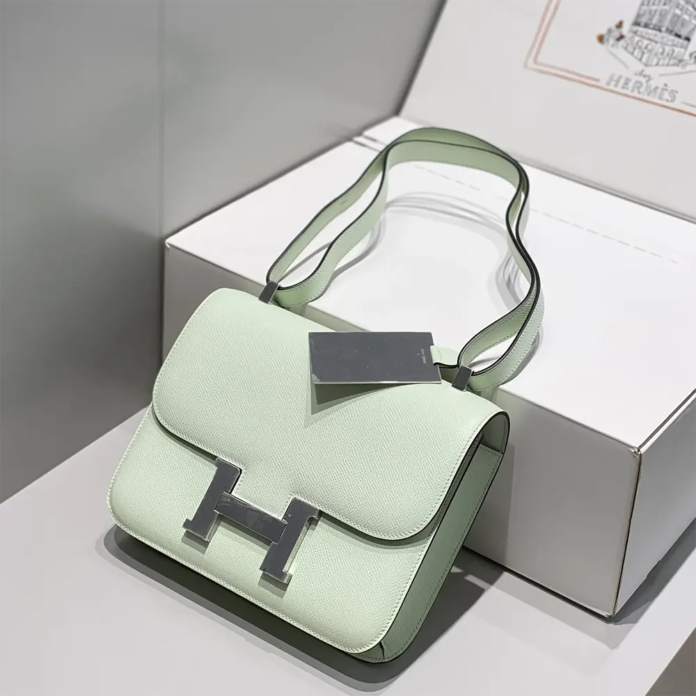Close-up of silver ‘H’ clasp on Hermes Constance 18 Bag Lime