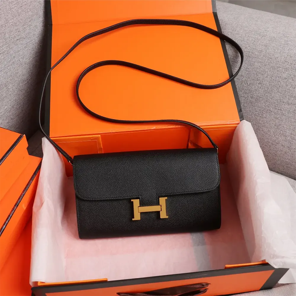 Close-up of gold Constance H clasp on Hermes Women Constance Long To Go