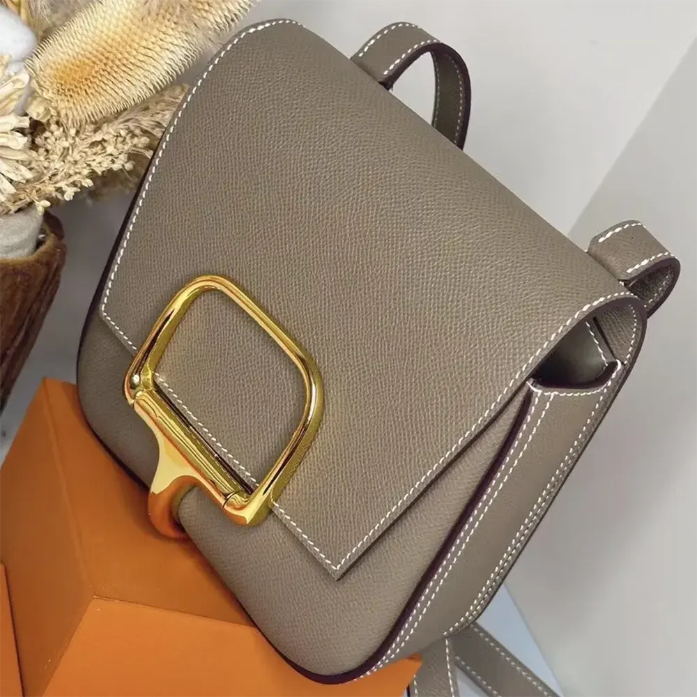 Side angle showing structured silhouette of Hermes Women Della Cavalleria Mini Bag