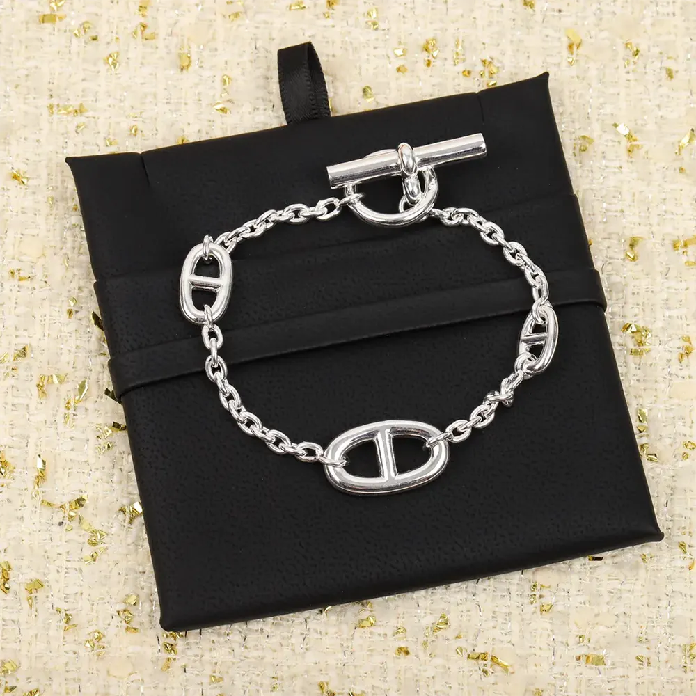 Styled wrist wearing Hermes Women Farandole Bracelet with elegant outfit