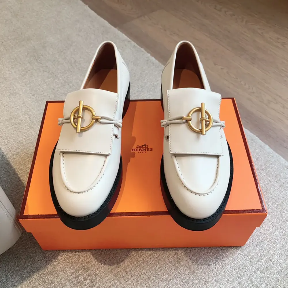 Close-up of signature silver hardware on Hermes Women Impact Loafer