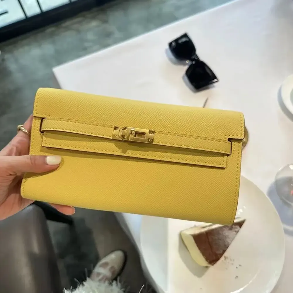 Close-up of Hermes turn-lock closure on Kelly To Go yellow bag