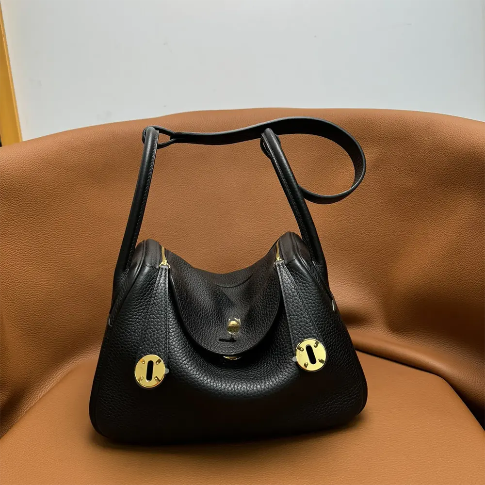 Side view showing rolled handles of Hermes Women Lindy 26 handbag