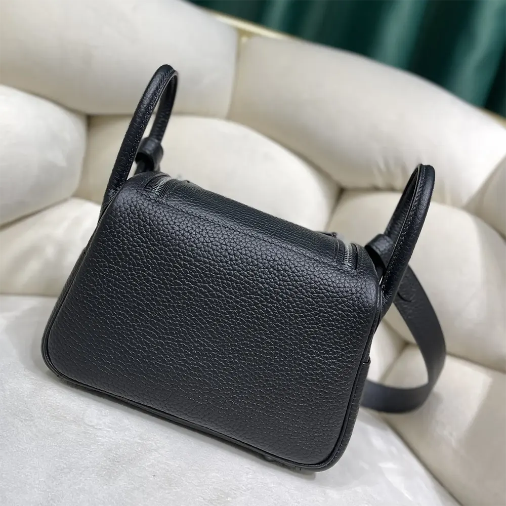 Side angle showing compact silhouette of Hermes Women Lindy Mini 19