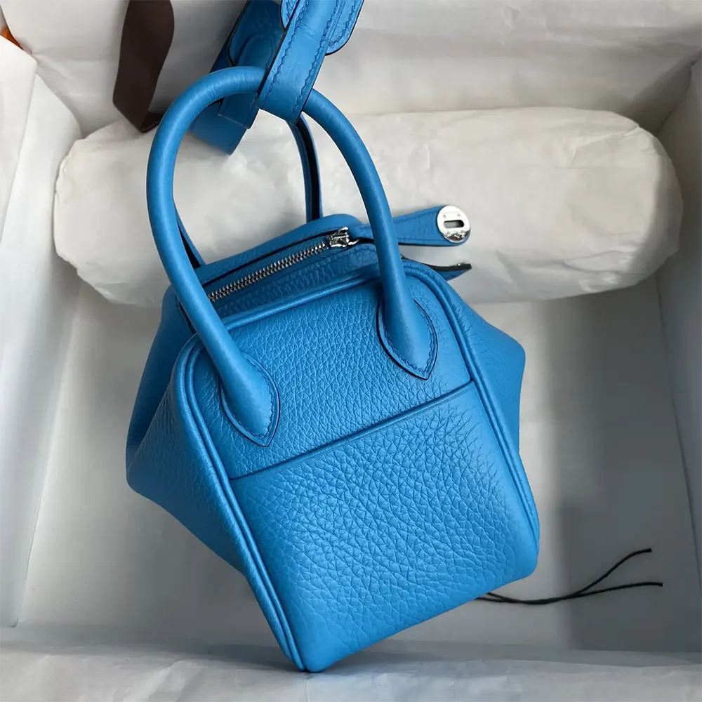 Side profile showing texture of blue Clemence leather on Lindy Mini 19