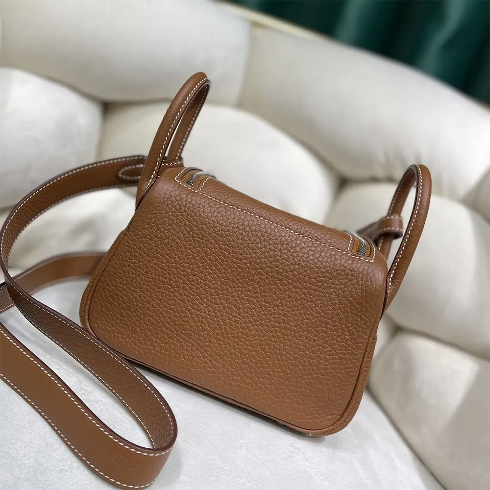 Side profile of Hermes Women Lindy Mini 19 shoulder bag showcasing relaxed silhouette