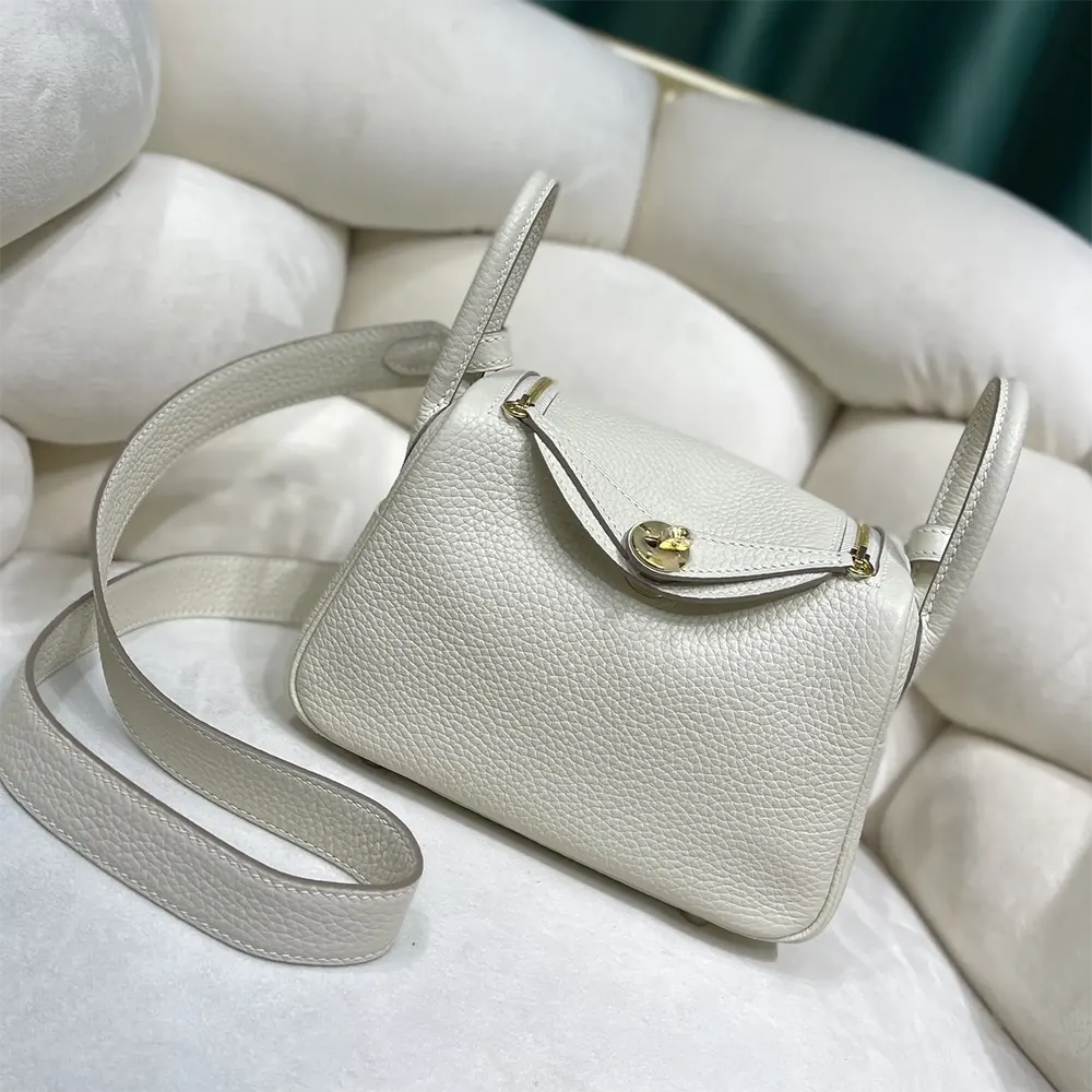 Close-up of gold hardware and white Clemence leather texture