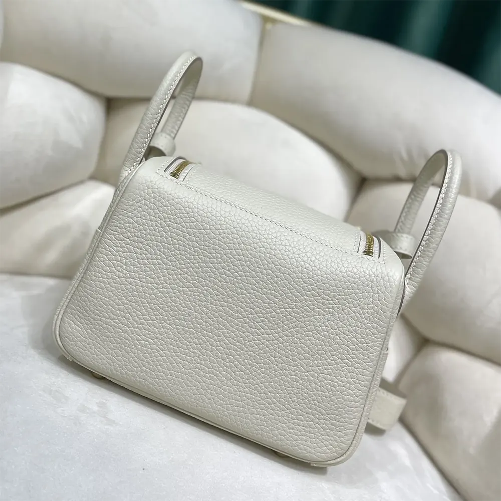 Side angle showing compact silhouette of Hermes Women Lindy Mini 19