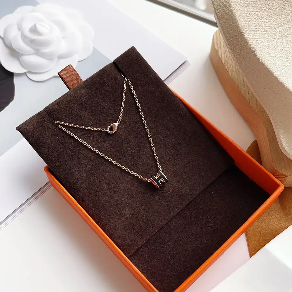 Side angle of Hermes Women Mini Pop H Pendant highlighting sleek silhouette