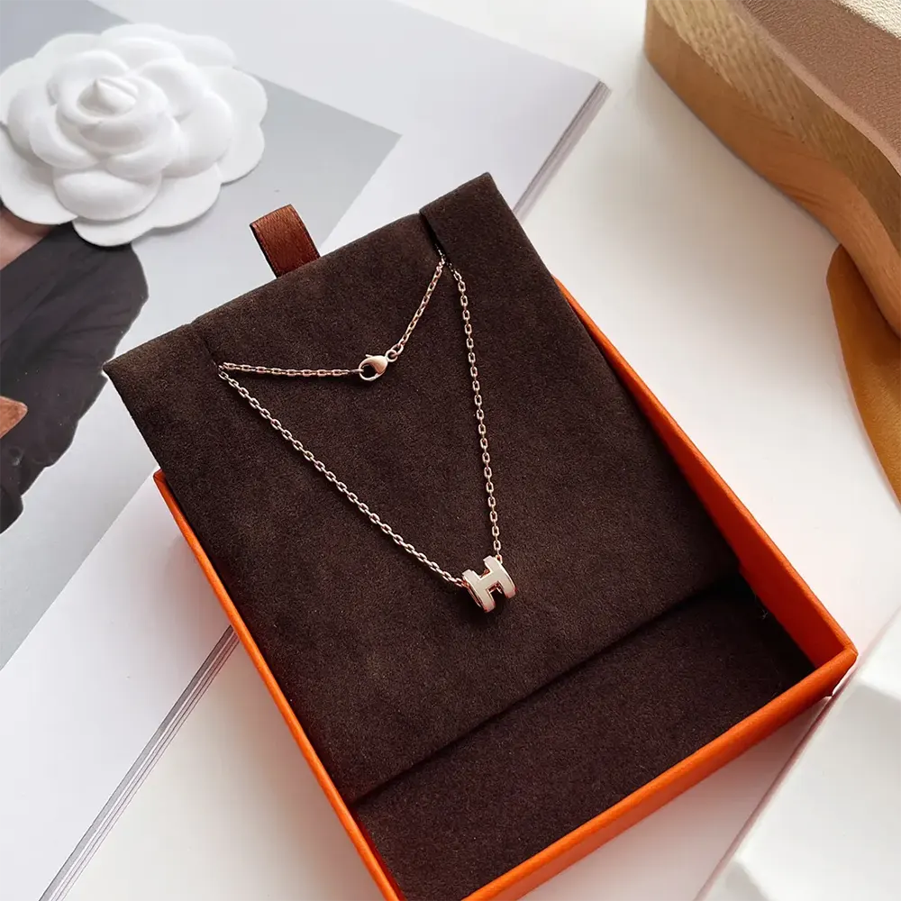 Side angle showcasing slim profile and polished details of Hermes Women Mini Pop H Pendant