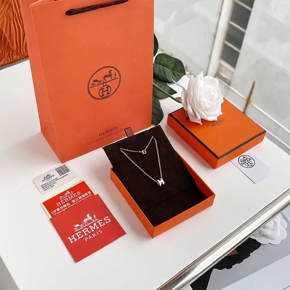 Close-up detail of silver 'H' hardware on Hermes Women Mini Pop H Pendant-White