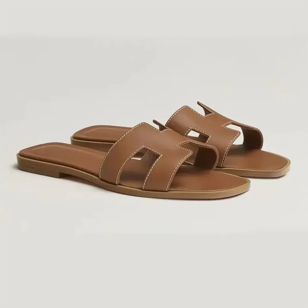 Side view of Hermes Women Oran Sandal-Brown showing leather cutout
