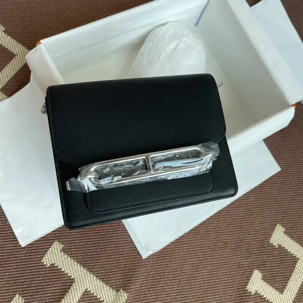 Close-up of silver H clasp on Hermes Women Roulis Mini Bag
