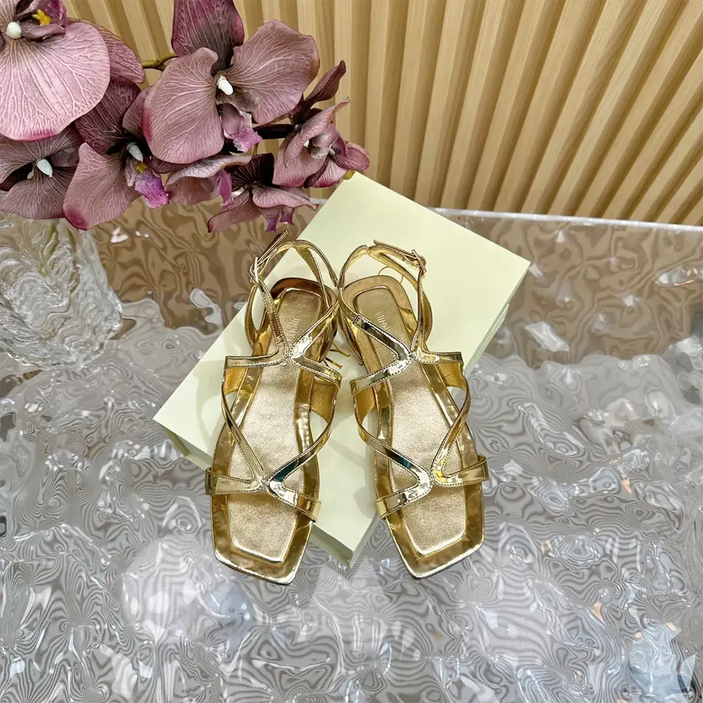 Close-up of metallic gold leather and embossed Jimmy Choo logo hardware