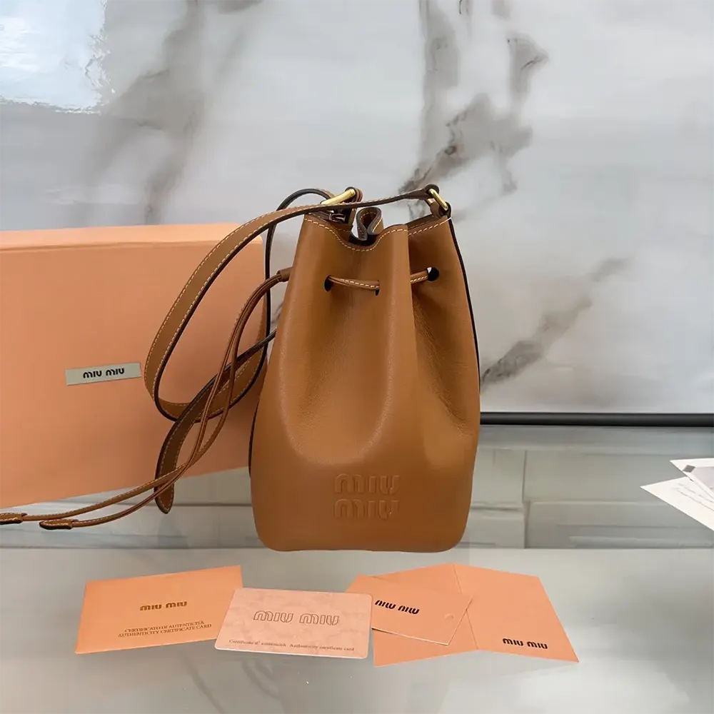 Close-up detail of silver-tone hardware on Miu Miu Women Leather Bucket Bag-Black