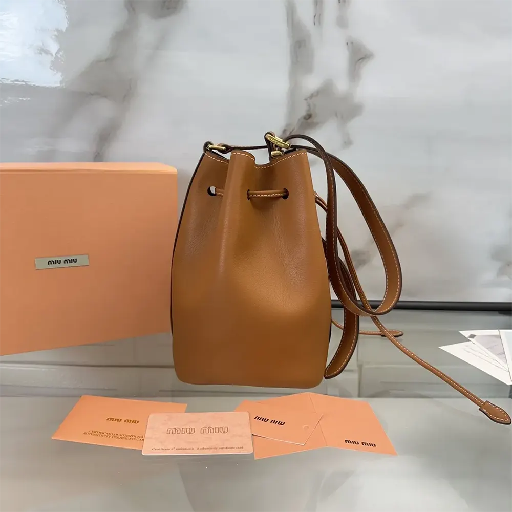 Side profile showcasing the smooth brown leather of Miu Miu Women Leather Bucket Bag-Black