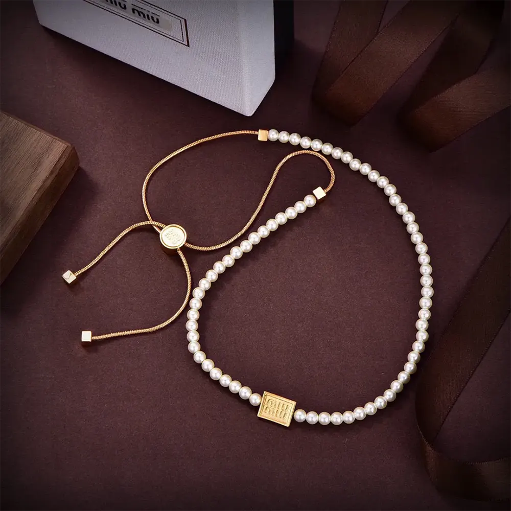 Close-up detail of artificial pearls and silver-tone clasp on choker