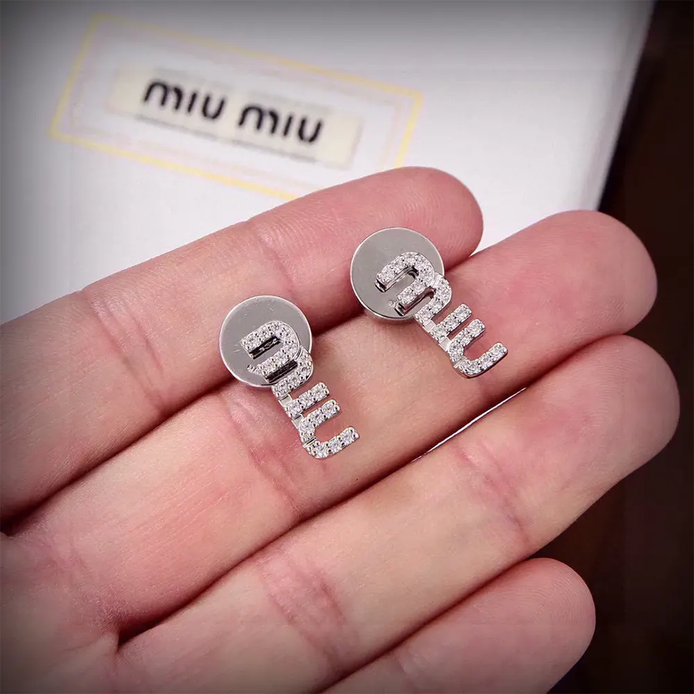 Side profile showing post closure of Miu Miu Women Metal Earrings