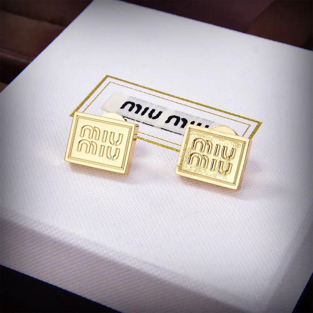Close-up detail of the perforated logo on Miu Miu Women Metal Earrings gold