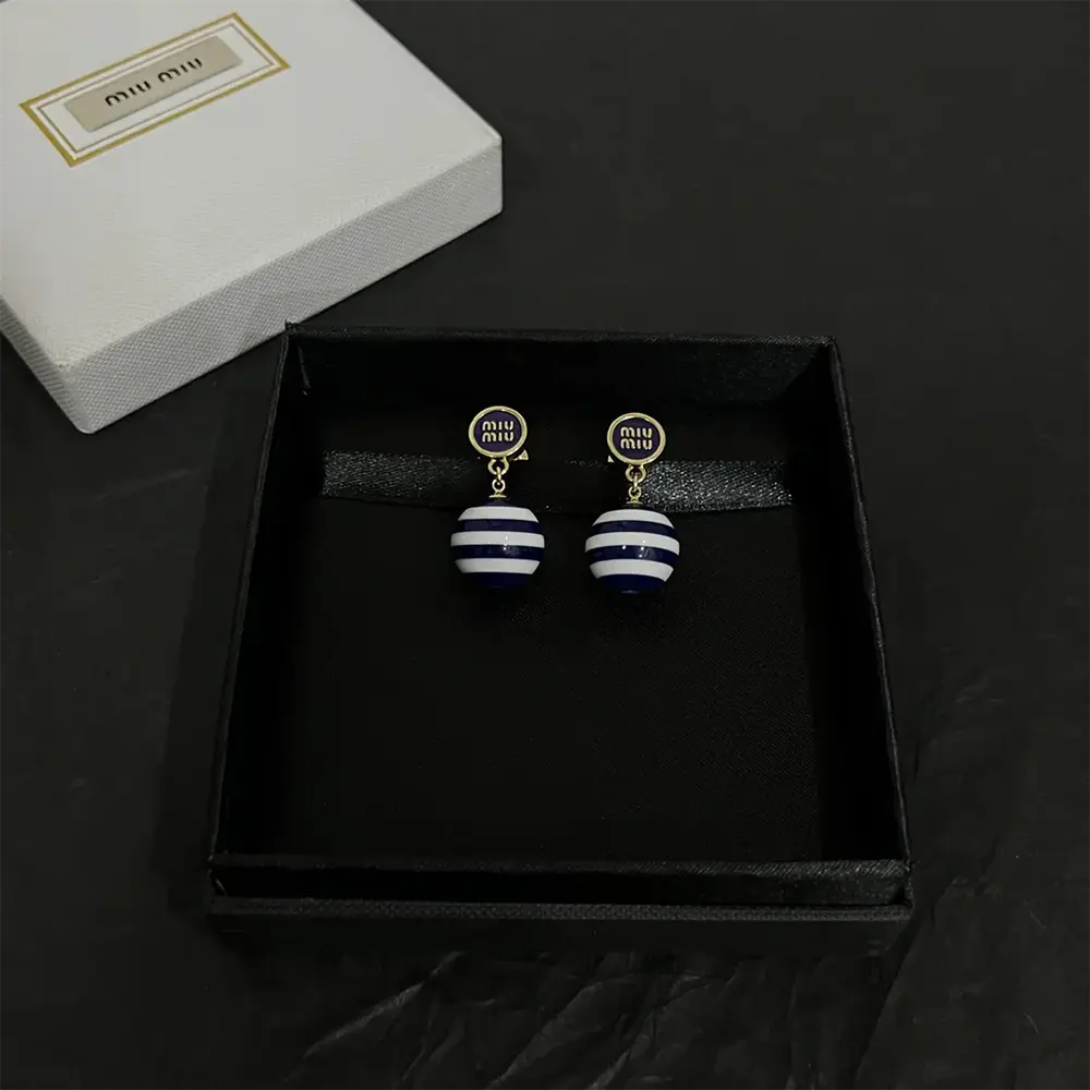 Side profile showing delicate drop silhouette of Miu Miu Women Metal and Pearl Earrings