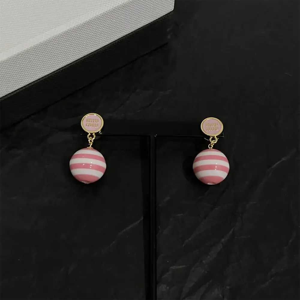 Side angle showing silhouette of Miu Miu Women Metal and Pearl Earrings
